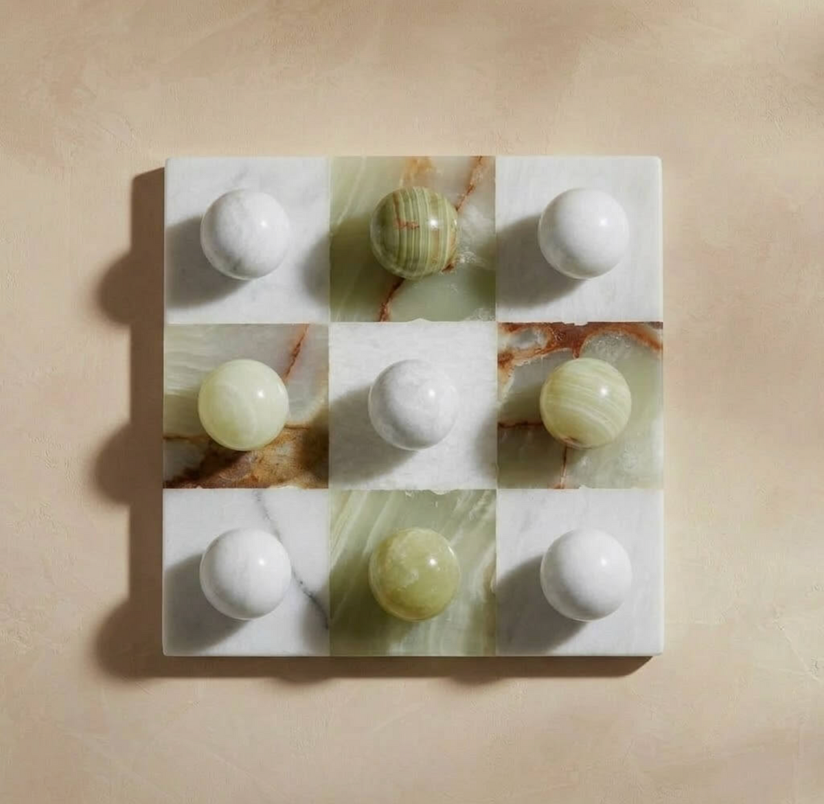 Overhead view of green onyx and white marble tic tac toe set