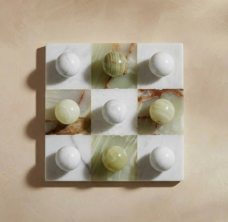 Overhead view of green onyx and white marble tic tac toe set